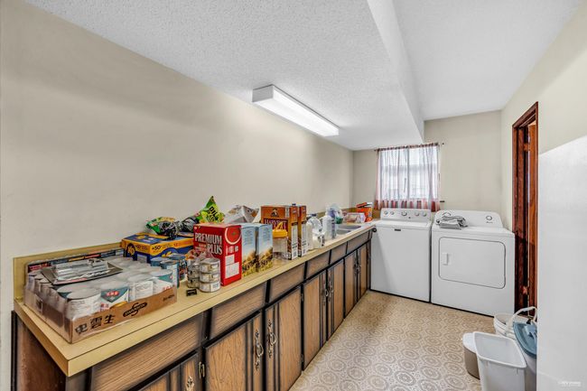 Laundry area with washing machine and dryer and a textured ceiling | Image 6