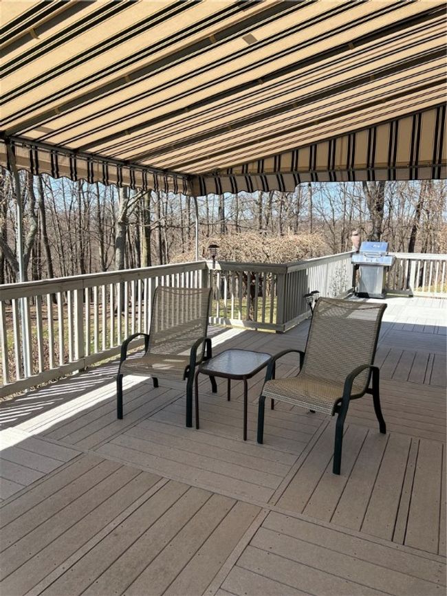 This custom-built deck offers a few steps down to right side of yard | Image 8