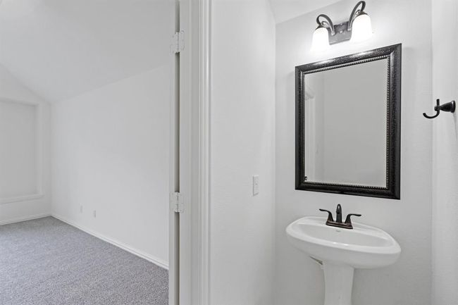 This convenient half bathroom is perfectly located next to the game room, offering easy access for both guests and family. | Image 14