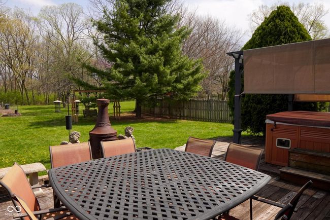 view of patio with outdoor dining area, a hot tub, and a deck | Image 28
