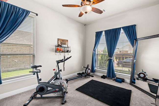 Exercise room with plenty of natural light, carpet flooring, and a ceiling fan | Image 30
