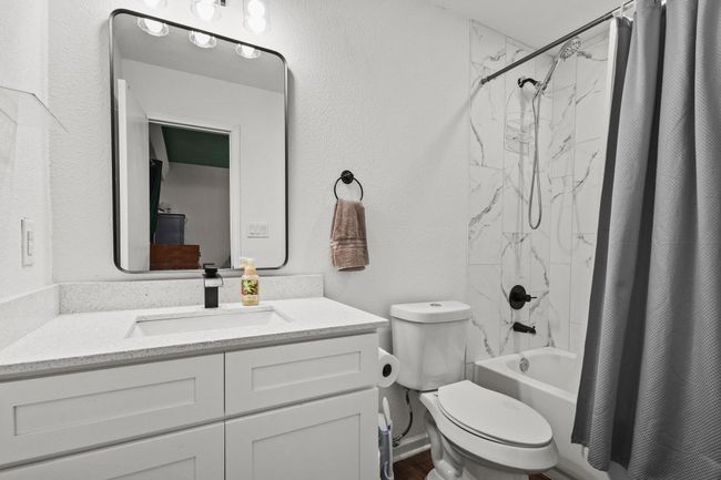 Bathroom featuring shower / bath combo, vanity, and toilet | Image 27