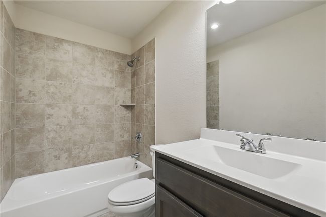 Bathroom featuring toilet, shower / tub combination, and vanity | Image 22
