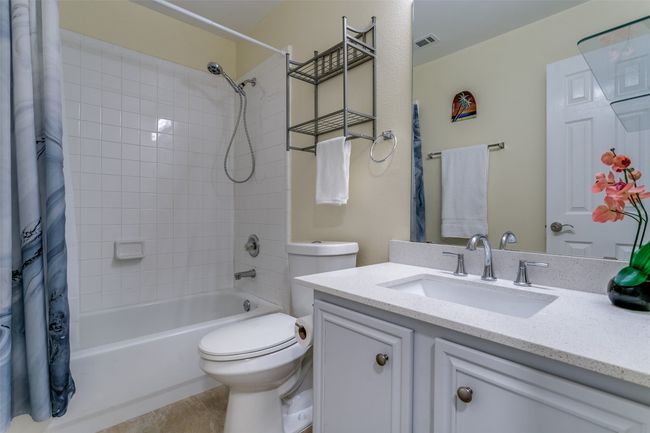 Full bathroom with shower / bath combo with shower curtain, vanity, and toilet | Image 20