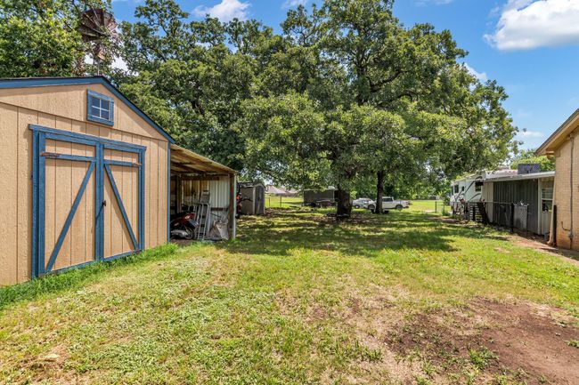 View of grassy yard featuring a storage unit | Image 28