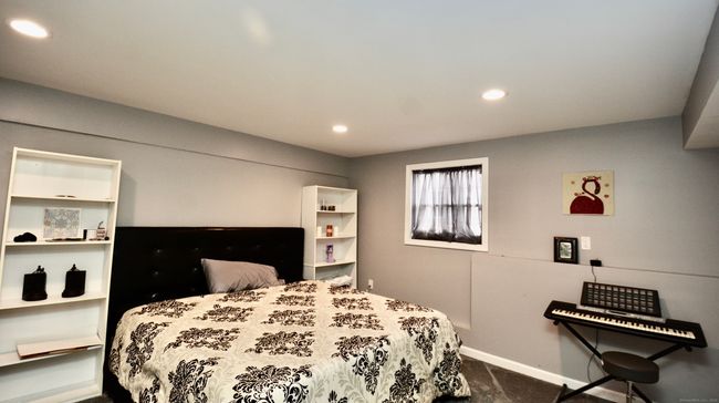 finished bedroom in basement with full window and closet | Image 33