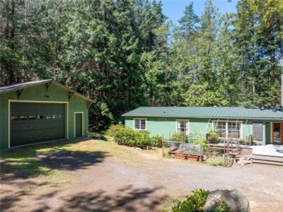 Home seen from driveway with two car shop/garage to left | Image 3