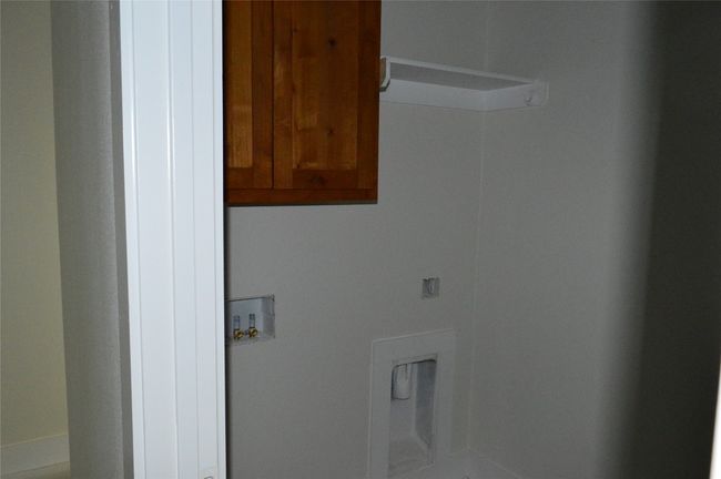 Laundry room featuring cabinet space and hookup for a washing machine | Image 15