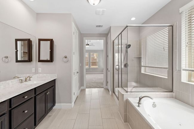 Full bath with visible vents, a shower stall, ceiling fan, and vanity | Image 25