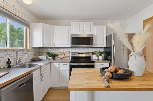 Subway tile backsplash and white cabinetry | Image 7
