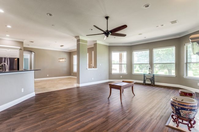 Living room with healthy amount of natural light, ceiling fan and recessed lighting | Image 10