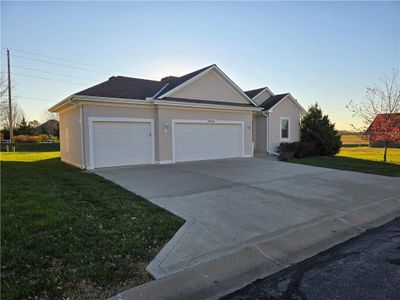 Ranch-style home with a garage and a yard | Image 2