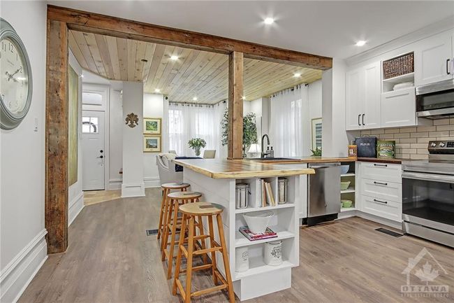 WOW! Faux wood beams separating kitchen from living/dining area. New flooring throughout home for easy flow | Image 8