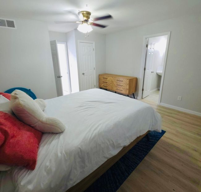 Bedroom 4, Guest or In-law suite. Featuring light wood-style floors, a ceiling fan, and ensuite bath | Image 26