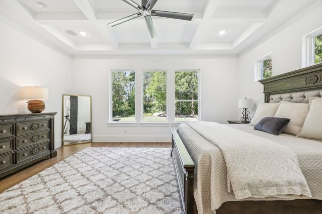 Bedroom with coffered ceiling, wood finished floors, beam ceiling, recessed lighting, and ceiling fan | Image 16