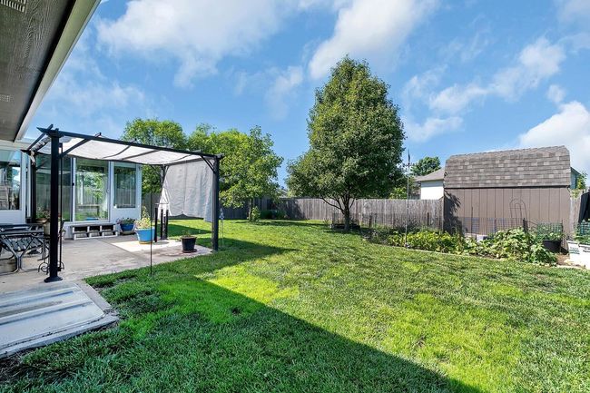 Fenced backyard with a storage shed, a patio, and a pergola | Image 4