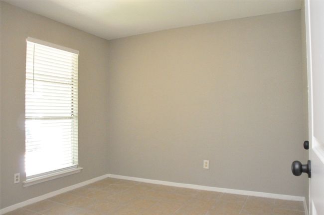 Spare room featuring light tile patterned flooring and baseboards | Image 20
