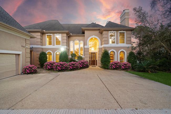 A spacious four-car garage and 1050+ square feet of additional space above for potential guest quarters or extra storage, coupled with ample room to construct a separate structure for a car collection, this property stands out as an effortless pick for a lifelong residence. | Image 5