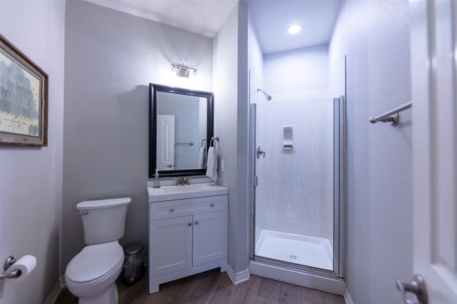 Bathroom with a stall shower, vanity, and wood finished floors | Image 26