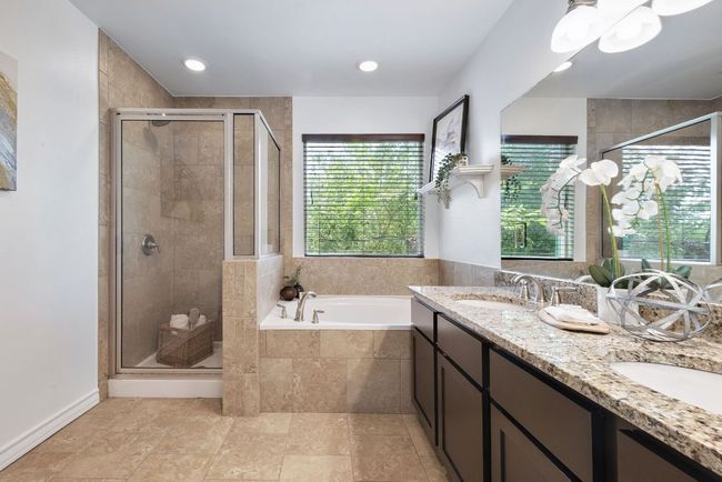 Full bath featuring a stall shower, a bath, double vanity, and recessed lighting | Image 26