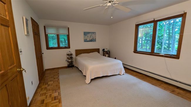 Primary Bedroom with bath featuring hardwood floors, 2 closets, ceiling fan | Image 12