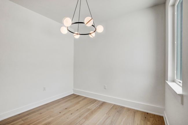 Unfurnished room featuring light wood-type flooring, baseboards, and a chandelier | Image 17