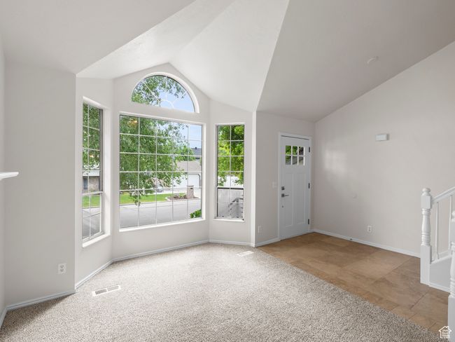 Foyer entrance featuring lofted ceiling, carpet, and baseboards | Image 8