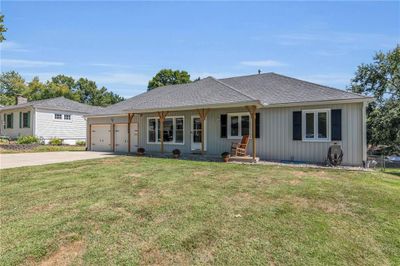 Ranch-style home featuring a garage, a porch, and a front yard | Image 2