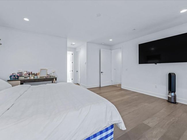 Bedroom with baseboards, wood finished floors, and recessed lighting | Image 13