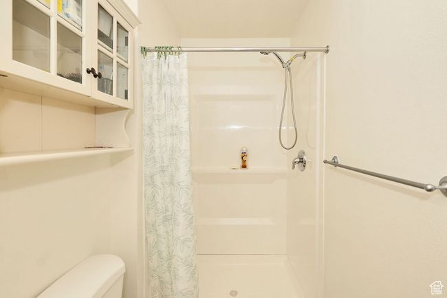 Bathroom featuring toilet and a stall shower | Image 25