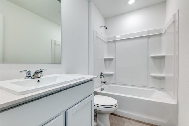 Full bath with vanity, bathing tub / shower combination, wood finished floors, and recessed lighting | Image 10