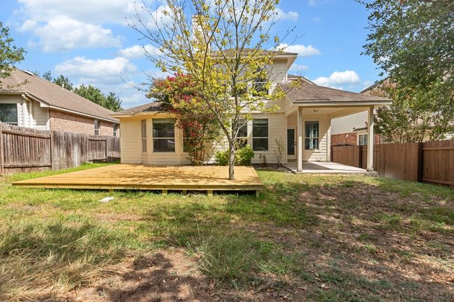 Back of house featuring a fenced backyard, a wooden deck, a shingled roof, and a patio | Image 30