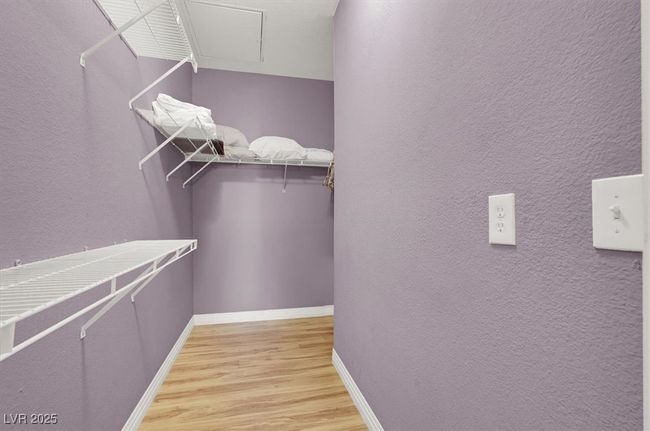 Walk in closet with light wood-style flooring | Image 23