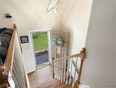 Entrance foyer with light wood-type flooring and an inviting chandelier | Image 3