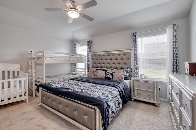 Bedroom featuring light carpet and ceiling fan | Image 15