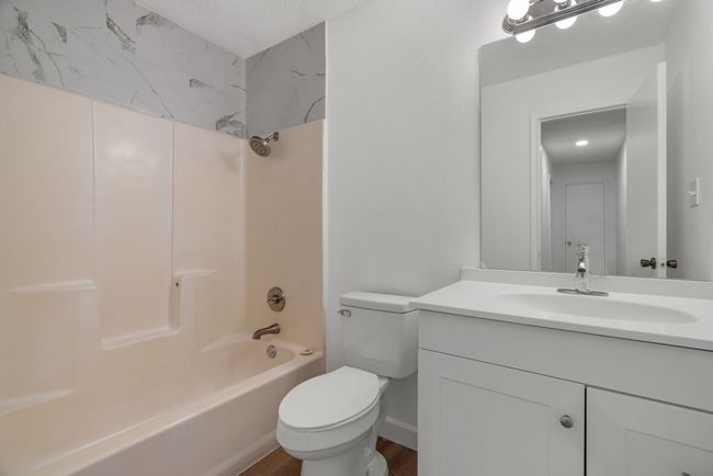 Full bathroom with vanity, shower combination, and wood finished floors | Image 28