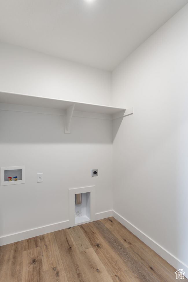 Laundry room with hookup for an electric dryer, wood finished floors, washer hookup, and baseboards | Image 15