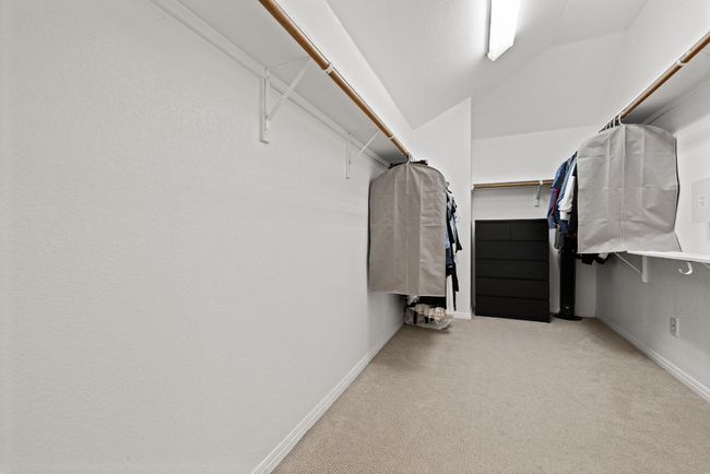 This expansive walk-in closet offers plenty of room for wardrobes of all sizes, with space for shelving, storage, and everything you need to keep life running smoothly | Image 24