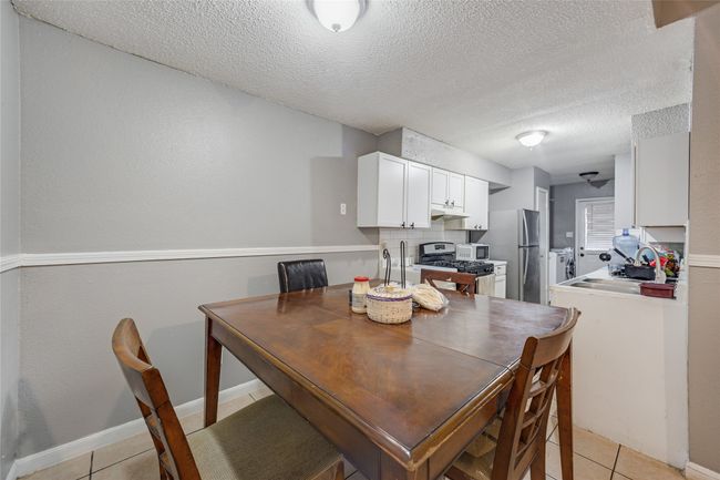 Unit B Tiled dining area with sink and a textured ceiling | Image 21