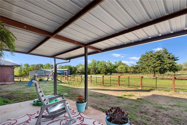 View of patio featuring a rural view, a fenced backyard, and a playground | Image 4