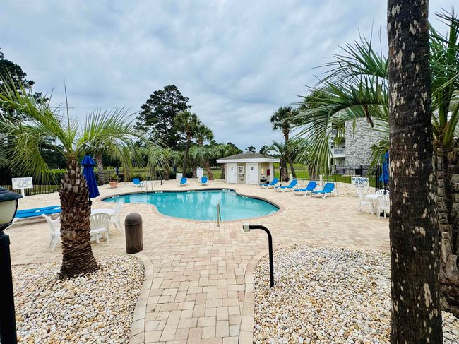 Community pool featuring fence and a patio area | Image 30