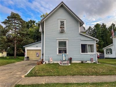 View of front property with a front yard and a garage | Image 1