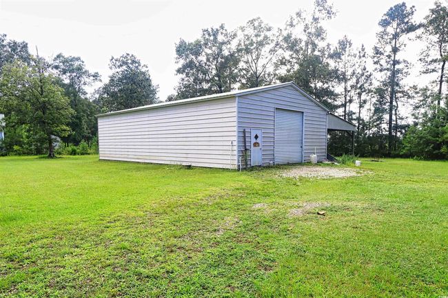 View of outbuilding with view of scattered trees | Image 25