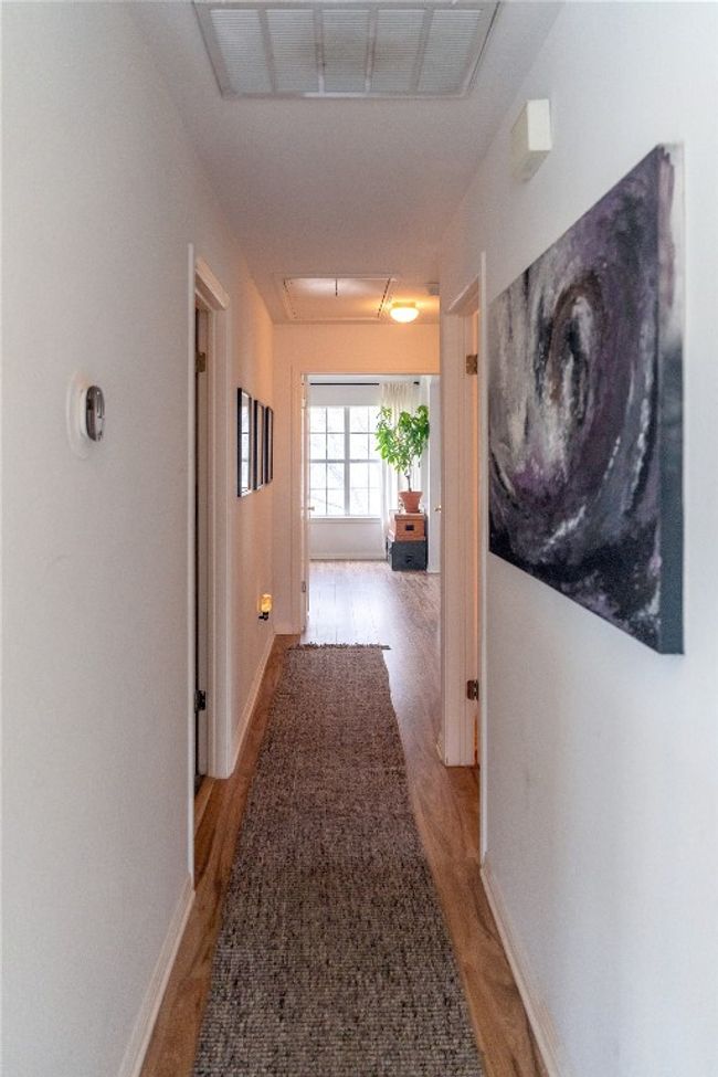 Corridor featuring attic access and light wood finished floors | Image 26
