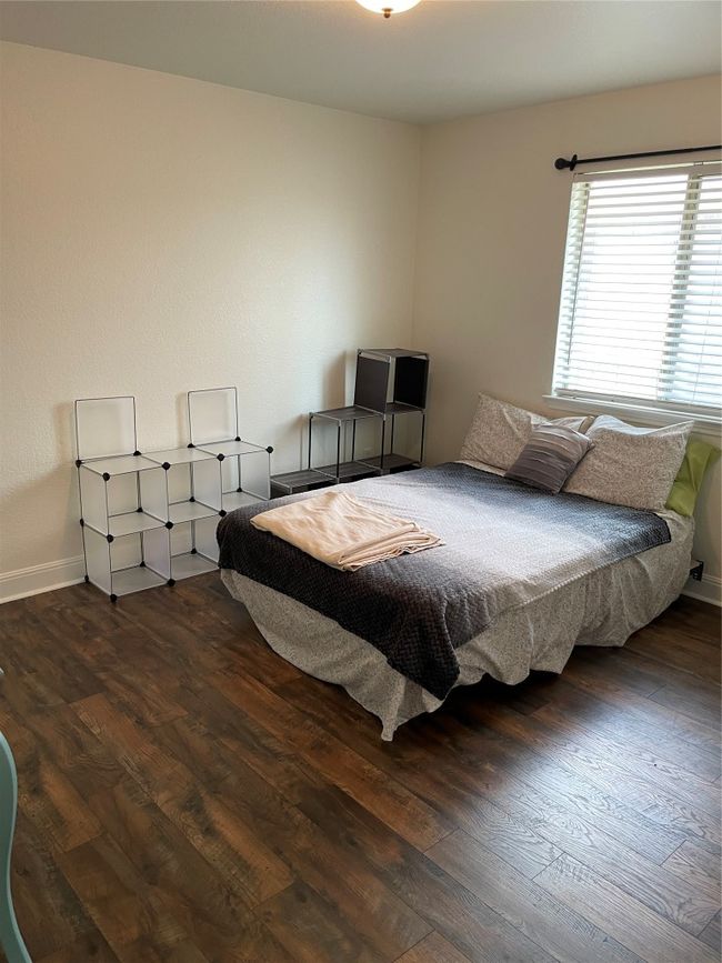 Bedroom with wood finished floors and baseboards | Image 19