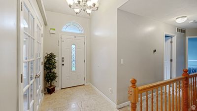 Foyer featuring a notable chandelier | Image 3