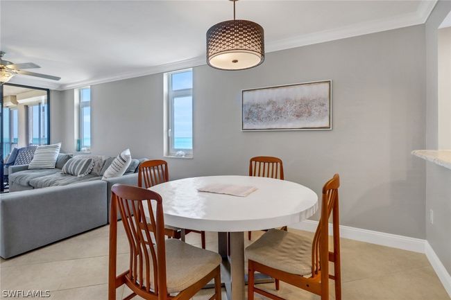 Dining space featuring crown molding, light tile patterned floors, and ceiling fan | Image 12