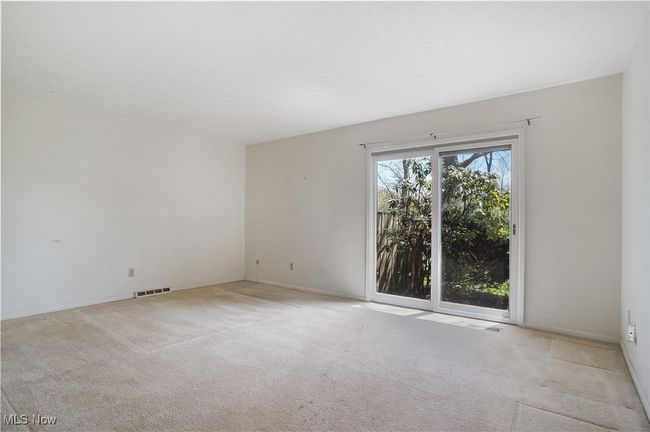 Spare room featuring light carpet, baseboards, and visible vents | Image 28
