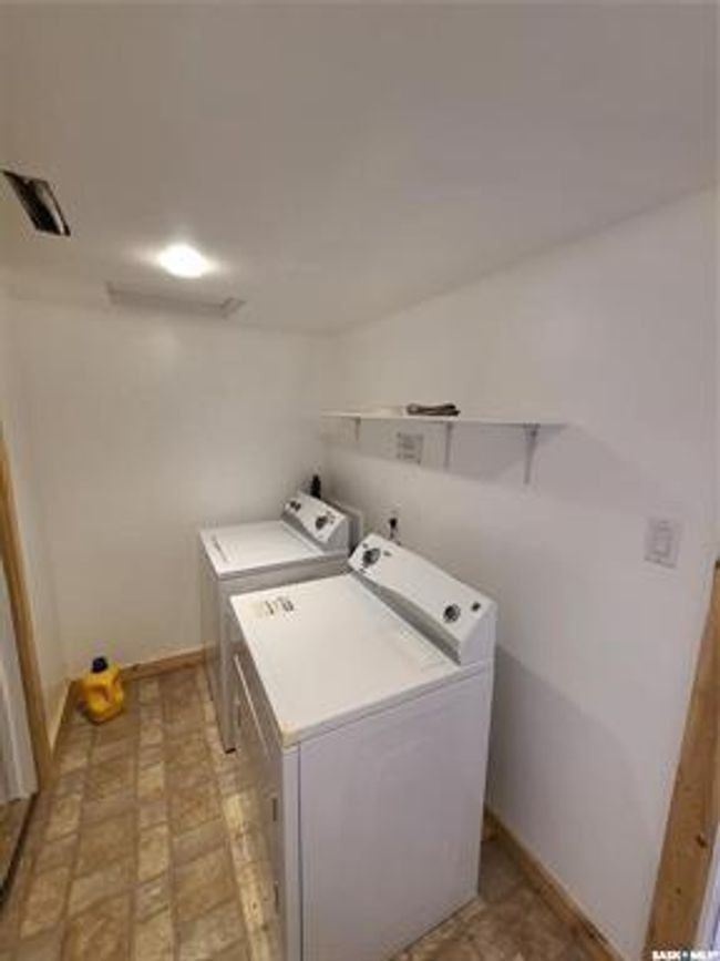 Clothes washing area featuring washing machine and dryer and light tile patterned flooring | Image 48