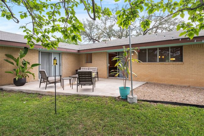 Rear view of property featuring a patio, a yard, outdoor lounge area, and brick siding | Image 5